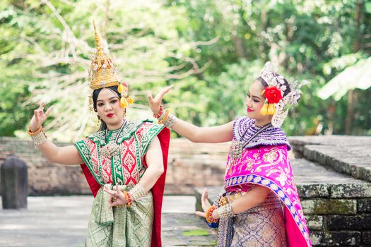 Asian woman wearing typical, traditional Thai Dress. It is literally means "Thai outfit", National costume.
