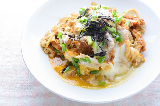 Japanese traditional food, Tonkatsu deep-fried pork cutlet on top with eggs
