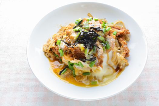 Japanese traditional food, Tonkatsu deep-fried pork cutlet on top with eggs
