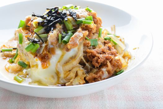 Japanese traditional food, Tonkatsu deep-fried pork cutlet on top with eggs
