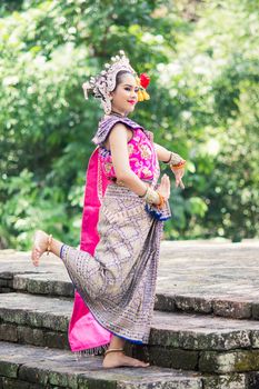 Asian woman wearing typical, traditional Thai Dress. It is literally means "Thai outfit", National costume.
