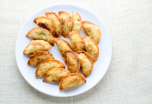 Japanese Fried Dumplings, the half moon-shaped dumplings served in Asian restaurants as an appetiser or side dish, pork and vegetable filling.
