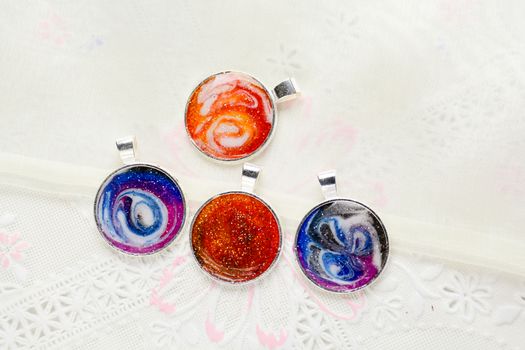 Create galaxy drink coasters using resin, glitter and pigment powders, handmade items. Suitable for keychains, necklace and pendant.
