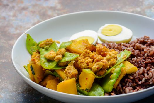 Stir Fry Snow Peas with pumpkin and chicken, served with brown rice and boiled egg
