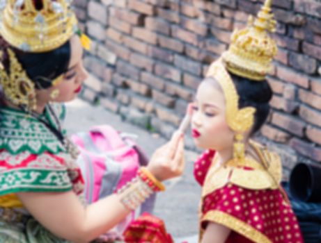 Asian woman wearing typical, traditional Thai Dress. It is literally means "Thai outfit", National costume.
