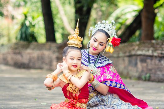 Asian woman wearing typical, traditional Thai Dress. It is literally means "Thai outfit", National costume.
