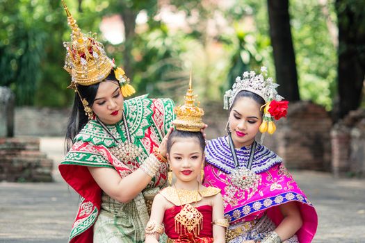 Asian woman wearing typical, traditional Thai Dress. It is literally means "Thai outfit", National costume.
