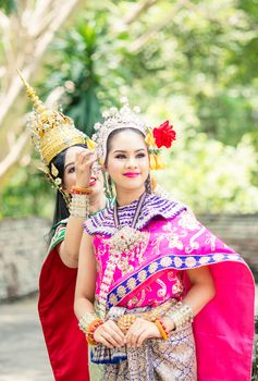 Asian woman wearing typical, traditional Thai Dress. It is literally means "Thai outfit", National costume.
