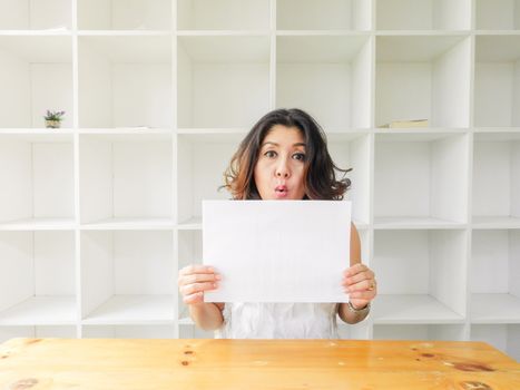 Attractive beautiful woman holding blank white paper.
