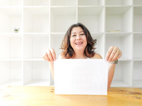 Attractive beautiful woman holding blank white paper.
