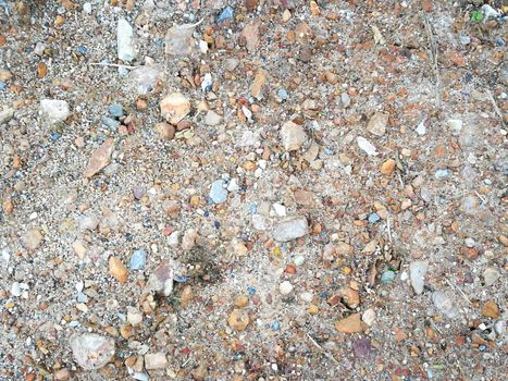 Blur small stones and sands on the road used as background or texture. Close up textured stone.
