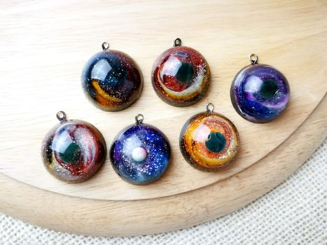 Create galaxy drink coasters using resin, glitter and pigment powders, handmade items. Suitable for keychains, necklace and pendant.
