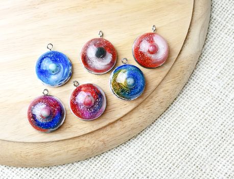 Create galaxy drink coasters using resin, glitter and pigment powders, handmade items. Suitable for keychains, necklace and pendant.
