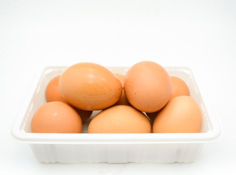 Eggs, fresh brown eggs in the white plastic box