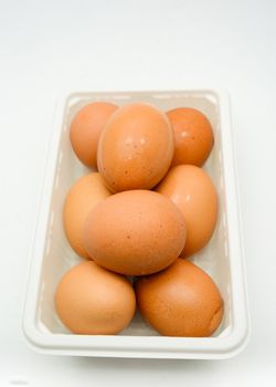 Eggs, fresh brown eggs in the white plastic box