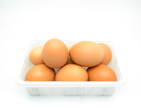 Eggs, fresh brown eggs in the white plastic box