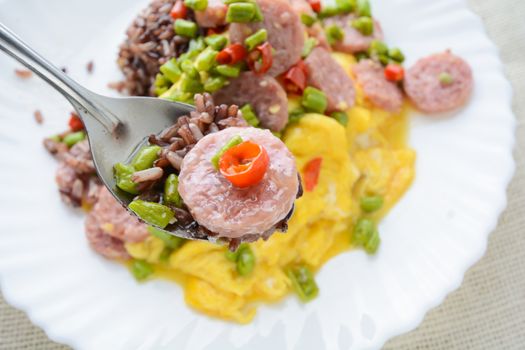 Fermented Pork Sausage Omelet with eggs and chilies, this dish would be delicious by fried in large amount of hot oil.