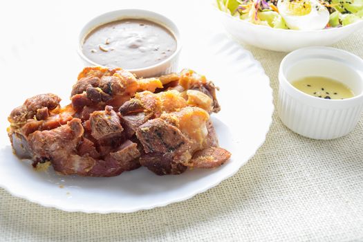 Deep fried pork knuckle with mushroom gravy source, fresh vegetable and salad cream source