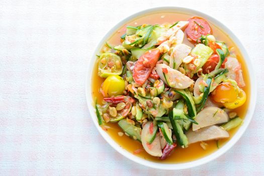 Cucumber salad with preserved pork sausages, Thai popular food called Som Tum Tang, Hot and spicy, mixed vegetables.