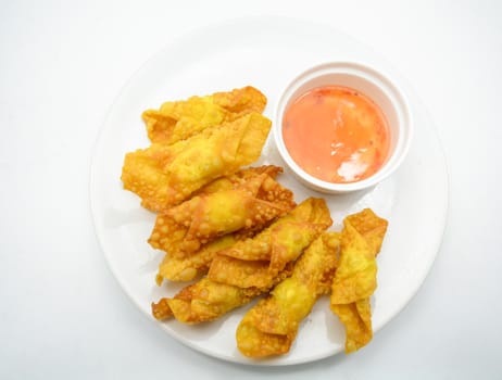 Deep Fried Won ton on white plate with dip source