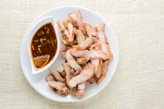 Grilled Pork with Thai Spicy Sauce, it can be served as an appetizer; it can also be served as an entrée with hot-off-the-splatter-guard sticky rice or plain steamed jasmine rice.