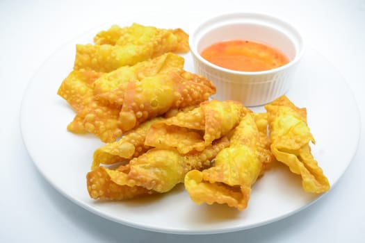 Deep Fried Won ton on white plate with dip source