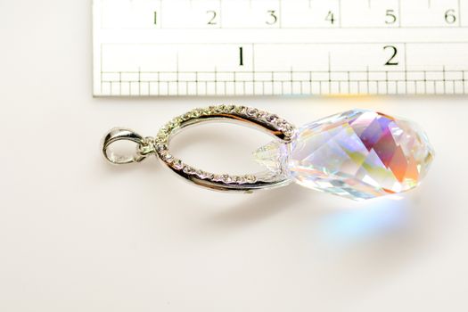 Crystal pendant on white fabric background
