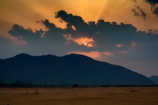 Sun settin behind Eastern Ghat Mountain range over Mahanadi river, copy space