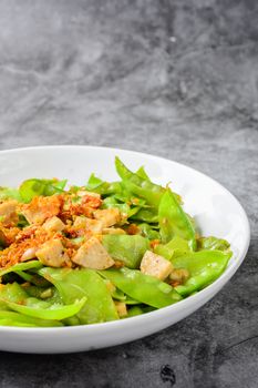 Stir Fry Snow Peas with Vietnamese Grilled Pork Sausage, topping with crispy fried shallots and garlics
