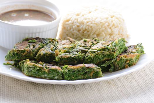 Shrimp Paste Sauce and Fried Egg with Climbing Wattle (Acacia Pennata), served with cooked rice.
