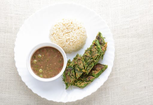 Shrimp Paste Sauce and Fried Egg with Climbing Wattle (Acacia Pennata), served with cooked rice.
