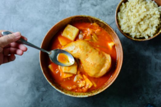 Korean traditional Kimchi soup with chicken and soft tofu
