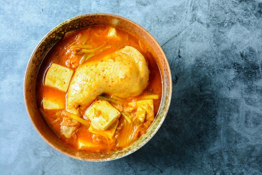 Korean traditional Kimchi soup with chicken and soft tofu
