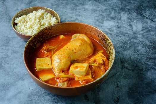 Korean traditional Kimchi soup with chicken and soft tofu
