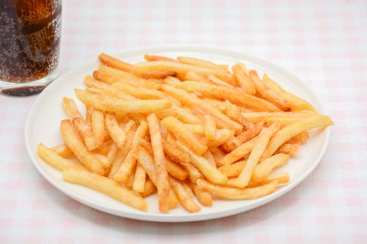 French fries on white dish and white background.