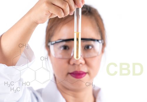 asian woman scientific research looking  cbd solution in tube