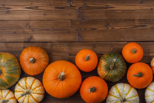 Many orange pumpkins on wooden background , Halloween concept , top view with copy space