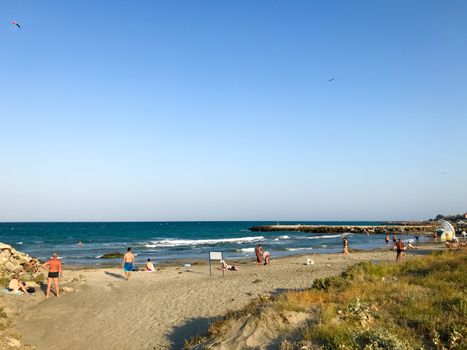 Pomorie, Bulgaria - September 01, 2019: People Relaxing On The Beach.