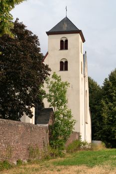 Panoramic image of the old parish church of Cologne Duennwald on a cloudy day, Germany