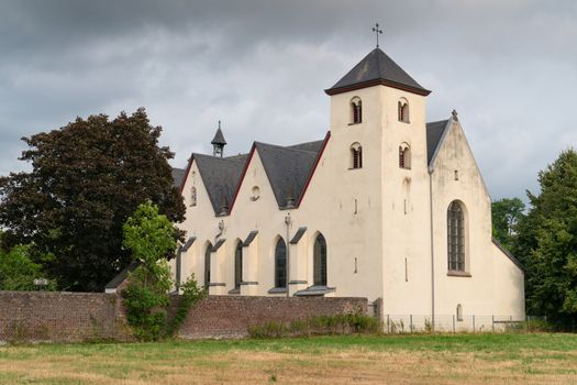 Panoramic image of the old parish church of Cologne Duennwald on a cloudy day, Germany