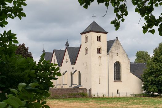 Panoramic image of the old parish church of Cologne Duennwald on a cloudy day, Germany