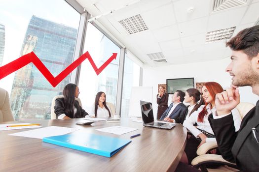 Business people discuss red arrow of income growth at meeting