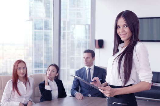 Group portrait of a professional business woman and team looking confidently at camera