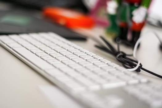 Modern grey keyboard with white keys. Selective focus