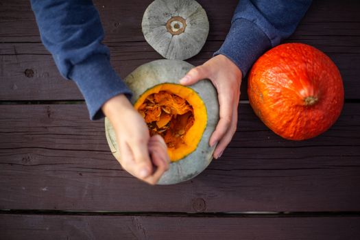 Hollowing out a pumpkin to prepare halloween lantern carving process