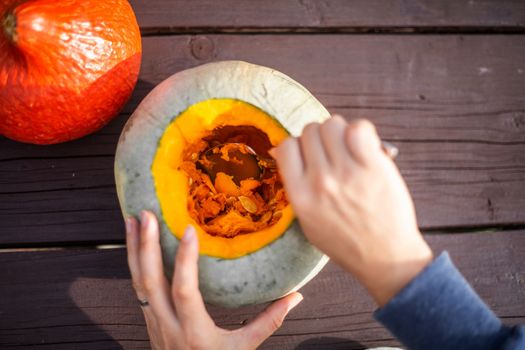 Hollowing out a pumpkin to prepare halloween lantern carving process