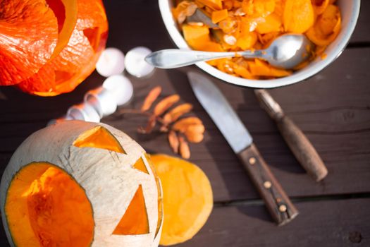 Preparing for halloween , carved jack o lantern pumpkin candles and knife on wooden table