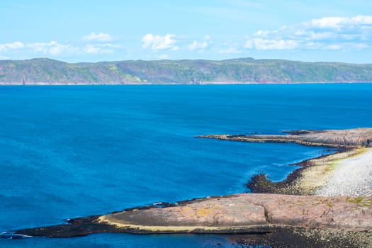 The shore of the Barents Sea (The Arctic ocean), view from the cliff . Near Teriberka, Murmansk, Russia. 