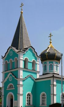 The Church with a turquoise bell tower.