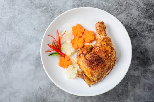 Hot and spicy baked chicken on white plate
